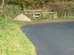 A pile of grit (salt and sand) by a roadside for lowering the melting point of ice