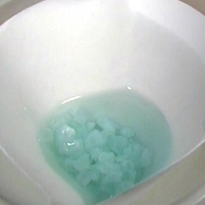 Crystals of Mohr's salt with green solution filtering away