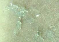 Magnified traces of Mohr's salt left behind on the filter paper