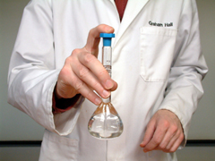 The solution is thoroughly mixed by inverting the stoppered flask several times