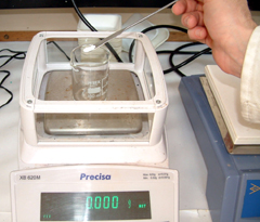 Anhydrous sodium carbonate is added carefully, without spillage