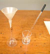 Volumetric flask and funnel ready to receive the solution