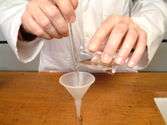 The glass rod is used to direct the liquid stream into the beaker without dripping