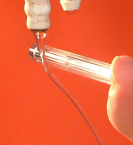 A stream of water is attracted towards a charged pen